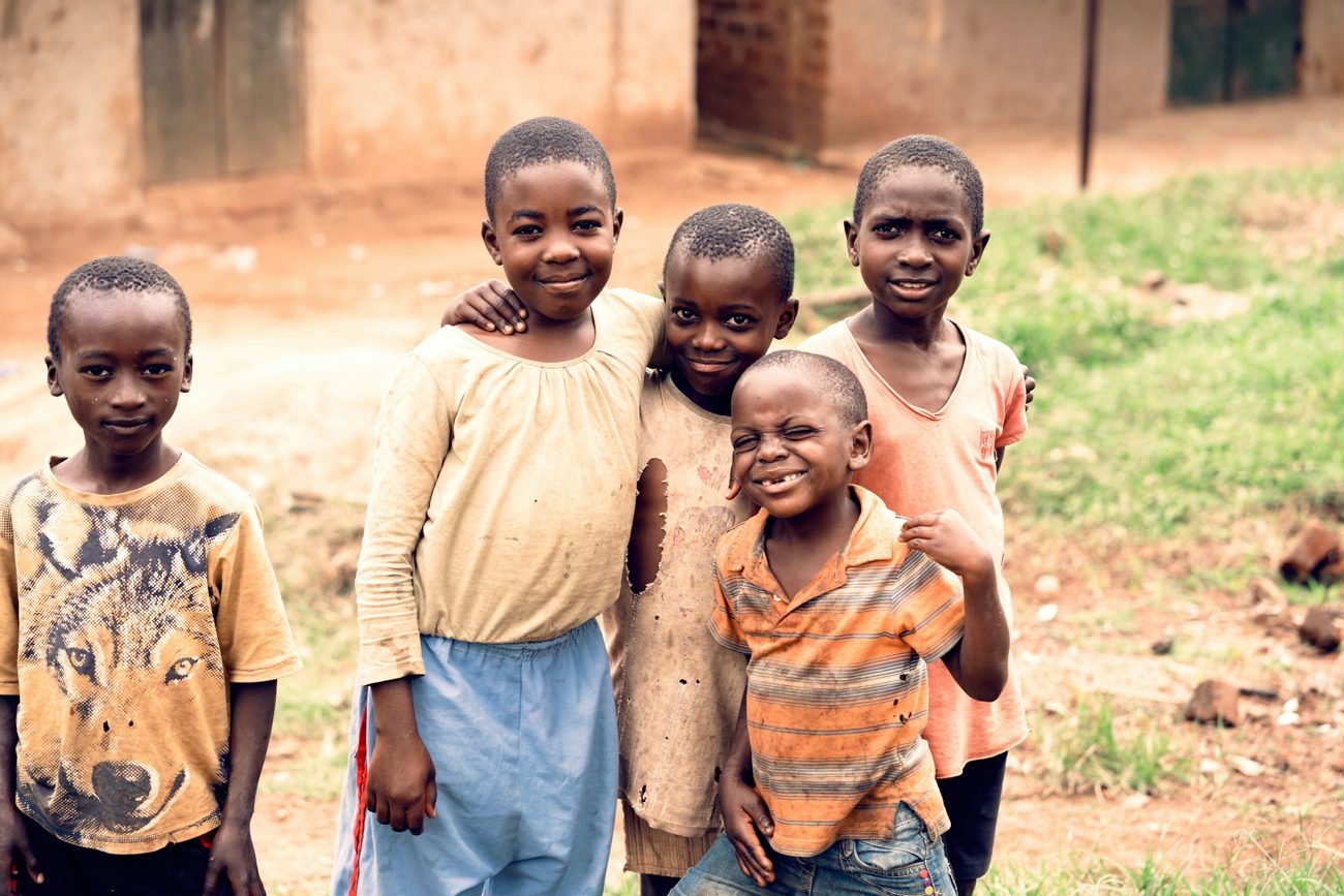 A group of smiling children standing together outdoors